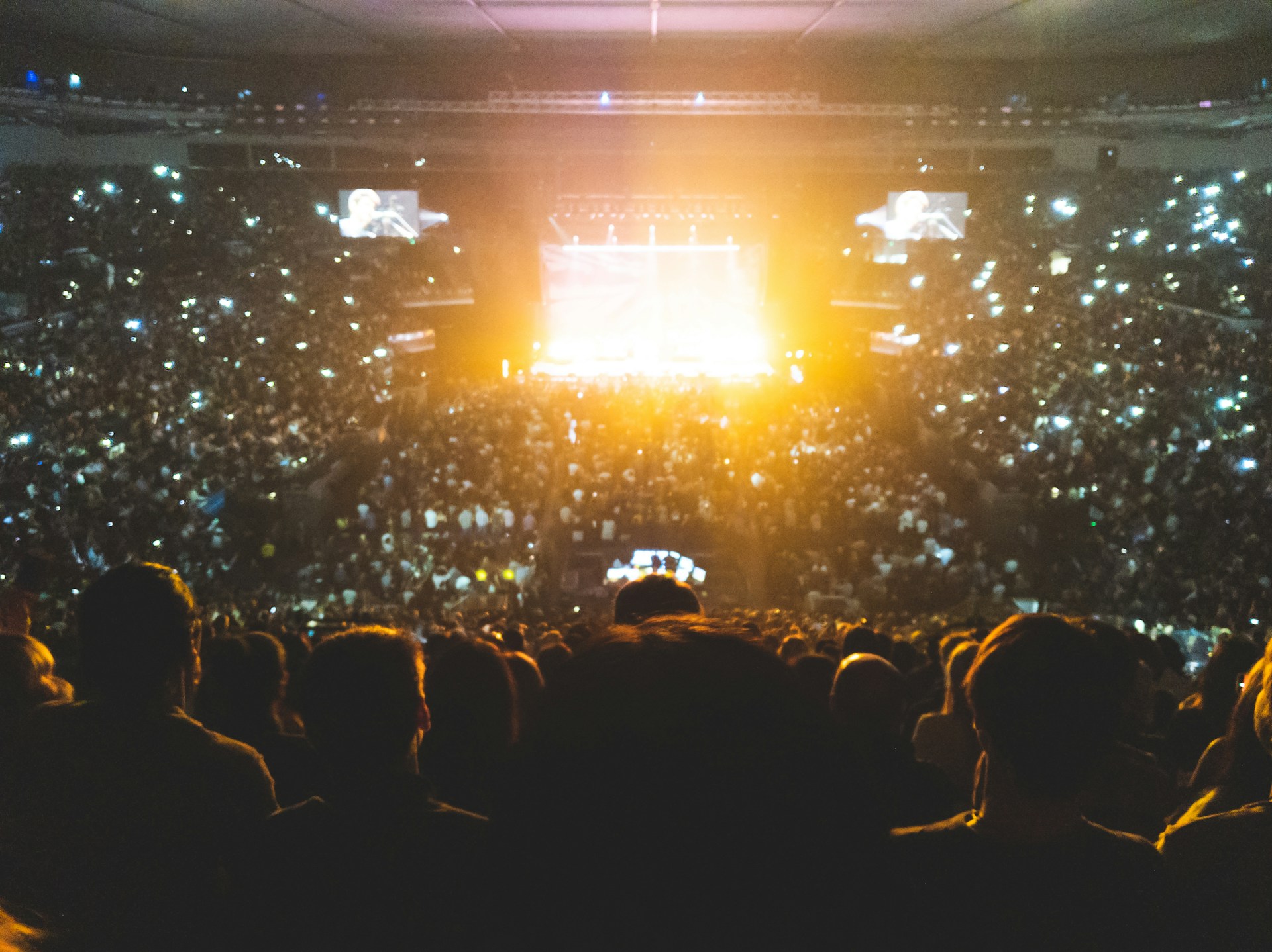 Sporting event crowd visibly holding up phones